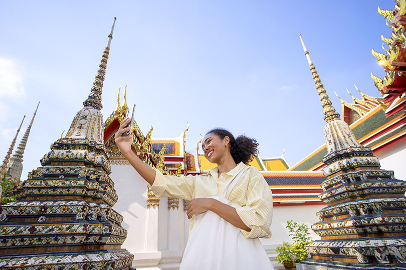 Taking a selfie at a Buddhist templesin Bangkok; credit Eyesfoto/UNSPLASH
